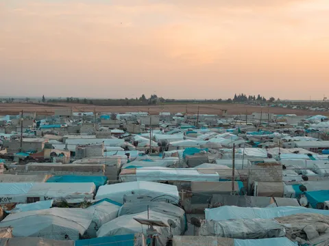 A large tent camp seen from above at dusk