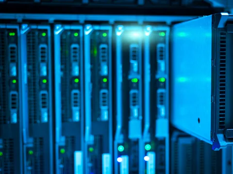 Rows of servers lit blue in a data centre rack