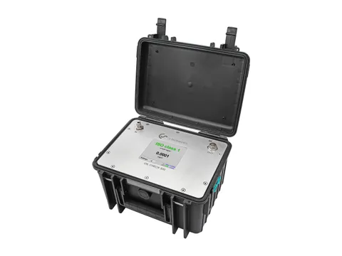 A portable oil vapour measurement instrument in an open case, its screen showing an ISO class