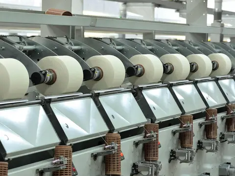 A row of yarn winding machines in a textile mill